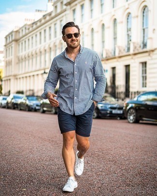 White and Black Gingham Long Sleeve Shirt Casual Outfits For Men: For comfort dressing with a modernized spin, you can rock a white and black gingham long sleeve shirt and navy shorts. Consider a pair of white canvas low top sneakers as the glue that brings your ensemble together.