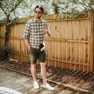 White and Black Plaid Long Sleeve Shirt Outfits For Men: A white and black plaid long sleeve shirt and olive shorts are among those super versatile menswear elements that can revolutionize your closet. This look is complemented wonderfully with white canvas low top sneakers.