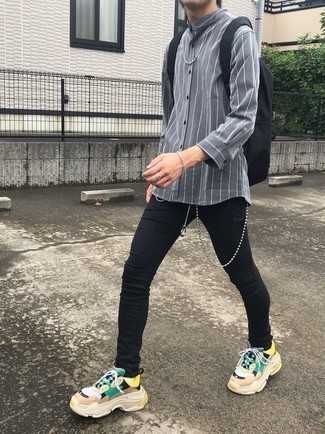 Men's Grey Vertical Striped Long Sleeve Shirt, Black Skinny Jeans, Multi colored Athletic Shoes, Black Canvas Backpack