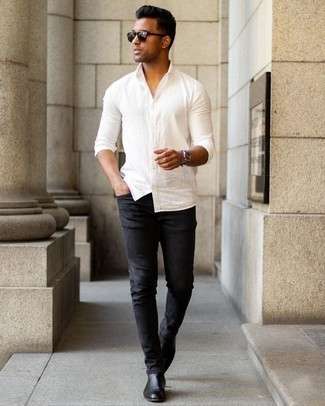 Black Skinny Jeans Outfits For Men: A white long sleeve shirt and black skinny jeans are the perfect foundation for an endless number of getups. Why not throw black leather chelsea boots in the mix for an added touch of refinement?
