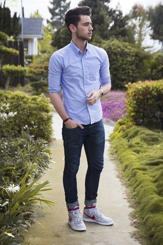 Navy Skinny Jeans Outfits For Men: This relaxed pairing of a light blue chambray long sleeve shirt and navy skinny jeans is a foolproof option when you need to look neat and relaxed in a flash. Introduce a pair of grey high top sneakers to this look to bring a touch of stylish effortlessness to this look.