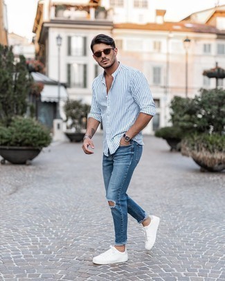 Men's White and Blue Vertical Striped Long Sleeve Shirt, Blue Ripped Skinny Jeans, White Leather Low Top Sneakers, Dark Brown Sunglasses