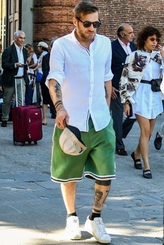 Green Sports Shorts Outfits For Men: A white long sleeve shirt and green sports shorts married together are a savvy match. Complete this ensemble with white canvas low top sneakers to easily turn up the fashion factor of any outfit.