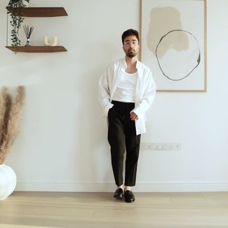 Black and White Leather Loafers Outfits For Men: A white long sleeve shirt and black chinos are a pairing that every smart man should have in his menswear collection. Tap into some David Beckham stylishness and complement your ensemble with a pair of black and white leather loafers.