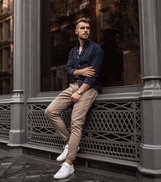 Brown Woven Leather Belt Outfits For Men: This sharp look is really pared down: a navy long sleeve shirt and a brown woven leather belt. For a more refined aesthetic, why not introduce a pair of white leather low top sneakers to the equation?