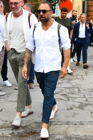 White Canvas Loafers Outfits For Men: Go for a simple but cool and relaxed choice by marrying a white long sleeve shirt and navy chinos. To add more class to your look, finish with a pair of white canvas loafers.