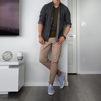 Light Blue Canvas Low Top Sneakers Outfits For Men: This combo of a charcoal chambray long sleeve shirt and khaki jeans is super easy to copy and so comfortable to work as well! A pair of light blue canvas low top sneakers looks perfectly at home with this look.