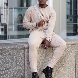 Beige Print Long Sleeve T-Shirt Outfits For Men: Display your chops in men's fashion by wearing this casual combination of a beige print long sleeve t-shirt and beige chinos. To give your outfit a dressier vibe, introduce black leather casual boots to the mix.
