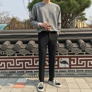 Black Canvas Low Top Sneakers Outfits For Men: This combo of a grey long sleeve t-shirt and black chinos is on the casual side but is also dapper and really stylish. A nice pair of black canvas low top sneakers ties this look together.