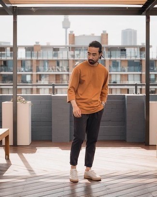 Brown Long Sleeve T-Shirt Outfits For Men: A brown long sleeve t-shirt and black vertical striped chinos are definitely worth being on your list of menswear essentials. Add a pair of beige canvas low top sneakers to the equation and the whole ensemble will come together quite nicely.