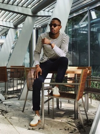 White and Navy Horizontal Striped Long Sleeve T-Shirt Outfits For Men: For a laid-back look, choose a white and navy horizontal striped long sleeve t-shirt and navy chinos — these two pieces fit beautifully together. If you're not sure how to finish off, complement this outfit with a pair of white and navy canvas low top sneakers.