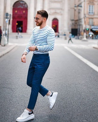 White and Navy Horizontal Striped Long Sleeve T-Shirt Outfits For Men: Consider teaming a white and navy horizontal striped long sleeve t-shirt with navy chinos for a comfortable look that's also put together. White and black leather low top sneakers act as the glue that brings this look together.