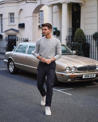 Grey Canvas Low Top Sneakers Outfits For Men: If you're on a mission for a casual yet sharp look, choose a grey long sleeve t-shirt and black chinos. Look at how well this ensemble is rounded off with a pair of grey canvas low top sneakers.