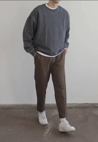 Charcoal Long Sleeve T-Shirt Outfits For Men: A charcoal long sleeve t-shirt and brown chinos are a good getup worth having in your current off-duty collection. Add a pair of white leather low top sneakers to the mix and ta-da: the outfit is complete.