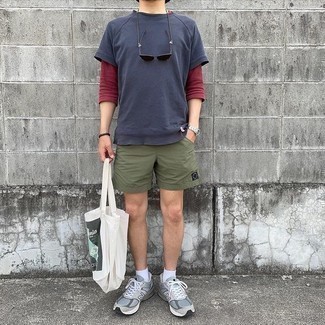 Olive Sports Shorts Outfits For Men: Consider wearing a navy crew-neck t-shirt and olive sports shorts if you seek to look casual and cool without spending too much time. Complete this outfit with a pair of grey athletic shoes and off you go looking boss.