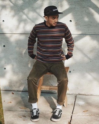 Multi colored Horizontal Striped Long Sleeve T-Shirt Outfits For Men: A multi colored horizontal striped long sleeve t-shirt and brown jeans are the kind of a foolproof off-duty ensemble that you so terribly need when you have no time. Let your styling credentials really shine by rounding off your ensemble with black and white canvas low top sneakers.