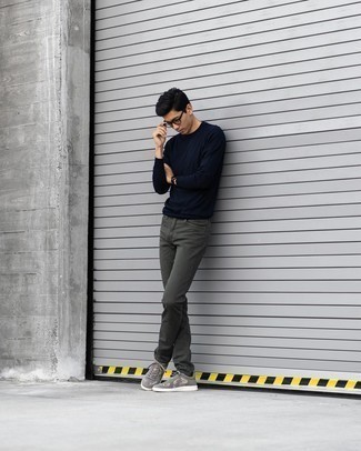 Dark Green Jeans Outfits For Men: If you're planning for a sartorial situation where comfort is prized, pair a navy long sleeve t-shirt with dark green jeans. A pair of grey camouflage canvas low top sneakers looks great completing this ensemble.