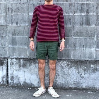 Navy Horizontal Striped Long Sleeve T-Shirt Outfits For Men: This combination of a navy horizontal striped long sleeve t-shirt and dark green shorts has this easy-going and effortless kind of vibe. A pair of white canvas low top sneakers can integrate well within a ton of ensembles.