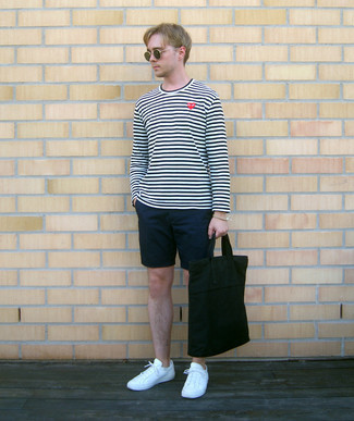 Black Canvas Tote Bag Outfits For Men: Reach for a white and navy horizontal striped long sleeve t-shirt and a black canvas tote bag for an easy-to-style menswear style. To give your outfit a sleeker aesthetic, complement your look with white canvas low top sneakers.