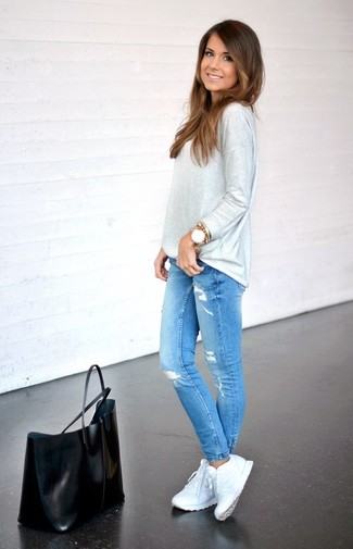 Grey Long Sleeve T-shirt Outfits For Women: This combination of a grey long sleeve t-shirt and blue ripped skinny jeans is solid proof that a safe casual look doesn't have to be boring. Amp up the appeal of this outfit by finishing with a pair of white athletic shoes.