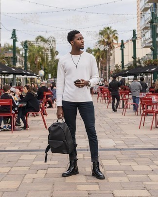 Black Leather Backpack Outfits For Men: Display your chops in men's fashion by teaming a white long sleeve t-shirt and a black leather backpack for a city casual look. Black leather casual boots are guaranteed to infuse a dose of elegance into your ensemble.