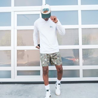 White Long Sleeve T-Shirt Outfits For Men: Wear a white long sleeve t-shirt and olive camouflage sports shorts for a stylish and easy-going getup. Inject your look with a dash of elegance by rounding off with a pair of white and black canvas high top sneakers.