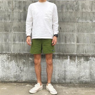 500+ Warm Weather Outfits For Men: For a modern casual ensemble without the need to sacrifice on comfort, we like this pairing of a white long sleeve t-shirt and olive sports shorts. White canvas low top sneakers will bring an added dose of style to an otherwise mostly casual look.
