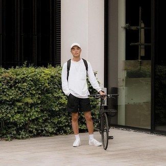 Black Sports Shorts Outfits For Men: Consider pairing a white long sleeve t-shirt with black sports shorts if you're on the hunt for an outfit option that is all about contemporary style. Kick up the dressiness of your look a bit with a pair of white canvas low top sneakers.