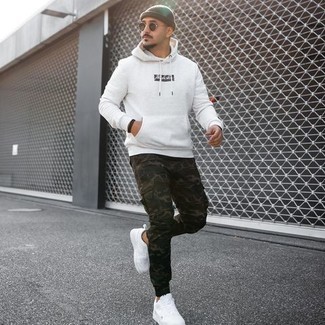 Men's Olive Beanie, White Canvas Low Top Sneakers, Dark Green Camouflage Cargo Pants, White and Black Print Hoodie