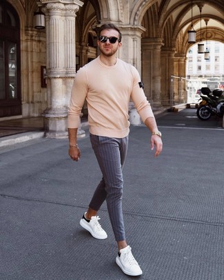 Men's Black Sunglasses, White and Black Leather Low Top Sneakers, Grey Vertical Striped Chinos, Beige Crew-neck Sweater