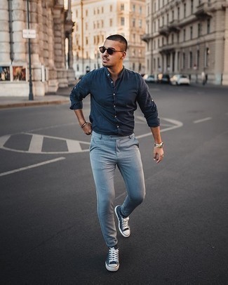 Men's Dark Brown Sunglasses, Navy and White Canvas Low Top Sneakers, Light Blue Vertical Striped Chinos, Navy Long Sleeve Shirt