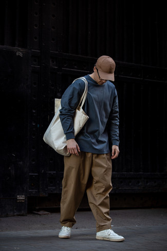 Men's White Canvas Tote Bag, White Leather Low Top Sneakers, Brown Chinos, Navy Long Sleeve T-Shirt