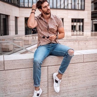 Men's Black Leather Belt, White Print Leather Low Top Sneakers, Light Blue Ripped Jeans, Multi colored Print Short Sleeve Shirt