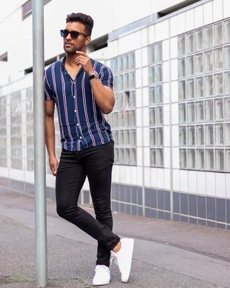 Men's Navy Sunglasses, White Canvas Low Top Sneakers, Black Jeans, Navy Vertical Striped Short Sleeve Shirt