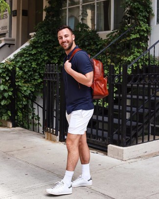 Men's Red Leather Backpack, White Leather Low Top Sneakers, White Shorts, Navy Short Sleeve Shirt