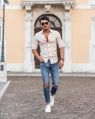 Men's Dark Brown Sunglasses, White Canvas Low Top Sneakers, Blue Ripped Skinny Jeans, Tan Vertical Striped Long Sleeve Shirt