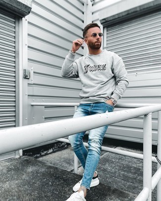 Men's Charcoal Sunglasses, White and Black Leather Low Top Sneakers, Blue Ripped Skinny Jeans, Grey Print Sweatshirt