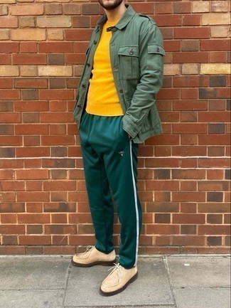 Mustard Crew-neck Sweater Outfits For Men: This casual combo of a mustard crew-neck sweater and dark green sweatpants is perfect when you need to look sharp in a flash. Infuse an added dose of style into your ensemble by finishing with beige suede desert boots.