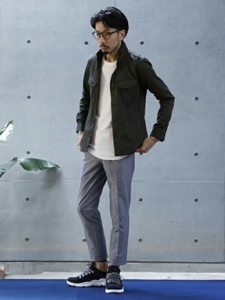 Olive Military Jacket Warm Weather Outfits For Men: An olive military jacket and grey chinos are a cool go-to outfit to have in your closet. Up this getup with a pair of navy and white athletic shoes.
