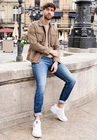 Beige Military Jacket Outfits For Men: A beige military jacket and blue jeans will give off this casually dapper vibe. Bring a dressed-down twist to an otherwise classic getup by rounding off with a pair of white athletic shoes.