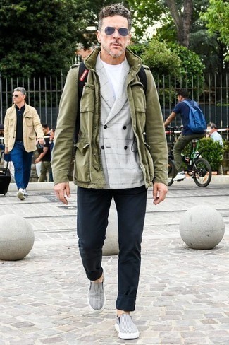 Navy and White Horizontal Striped Canvas Slip-on Sneakers Outfits For Men: If you're looking for a casual yet dapper outfit, wear an olive military jacket and navy chinos. A pair of navy and white horizontal striped canvas slip-on sneakers will tie the whole thing together.