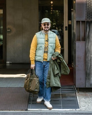 Olive Military Jacket Outfits For Men: Go for a pared down but laid-back and cool option by pairing an olive military jacket and blue jeans. White canvas low top sneakers will add a more laid-back aesthetic to an otherwise dressy getup.