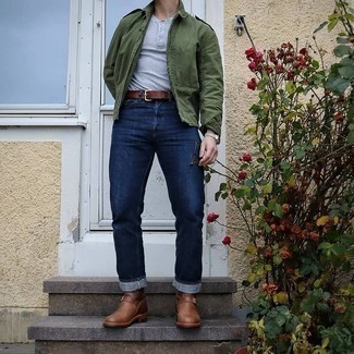 Olive Military Jacket Outfits For Men: This ensemble with an olive military jacket and navy jeans isn't so hard to pull off and is easy to change. Amp up this whole getup by finishing off with a pair of brown leather chelsea boots.