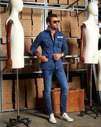 Blue Military Jacket Outfits For Men: Go for a blue military jacket and blue jeans for knockout menswear style. Bring an easy-going feel to this look by sporting white canvas low top sneakers.