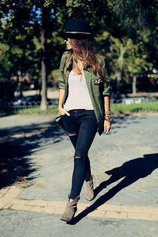 Tan Suede Ankle Boots Outfits: This laid-back pairing of an olive military jacket and navy ripped skinny jeans is clean, absolutely chic and super easy to copy! And if you need to easily up the style ante of this ensemble with footwear, why not add a pair of tan suede ankle boots to the mix?