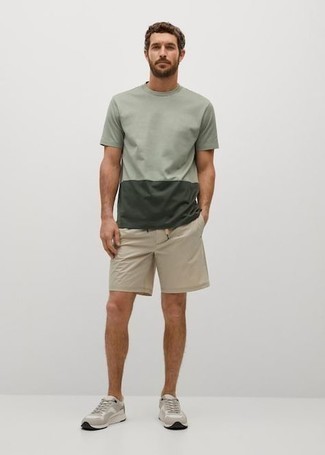 Green Crew-neck T-shirt Outfits For Men: Why not opt for a green crew-neck t-shirt and beige sports shorts? As well as very comfortable, both pieces look good matched together. If not sure as to what to wear on the footwear front, introduce a pair of grey athletic shoes to this ensemble.