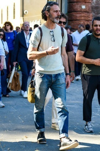 Blue Ripped Jeans Outfits For Men: In situations comfort is imperative, this combination of a mint knit crew-neck t-shirt and blue ripped jeans is a no-brainer. And if you need to instantly class up your look with a pair of shoes, why not complement this getup with a pair of black leather derby shoes?
