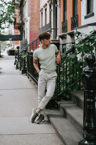 Dark Green Athletic Shoes Outfits For Men: Uber dapper and comfortable, this casual combination of a mint crew-neck t-shirt and grey chinos delivers wonderful styling opportunities. Let your sartorial prowess really shine by finishing your getup with a pair of dark green athletic shoes.