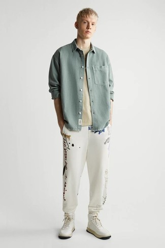 High Top Sneakers Outfits For Men: You'll be amazed at how very easy it is for any man to get dressed this way. Just a mint denim shirt and white print sweatpants. A great pair of high top sneakers pulls this outfit together.
