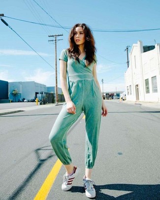 500+ Casual Cold Weather Outfits For Women: Rock a mint jumpsuit to assemble an interesting and current laid-back outfit. If not sure about what to wear in the footwear department, introduce a pair of white leather low top sneakers to the equation.